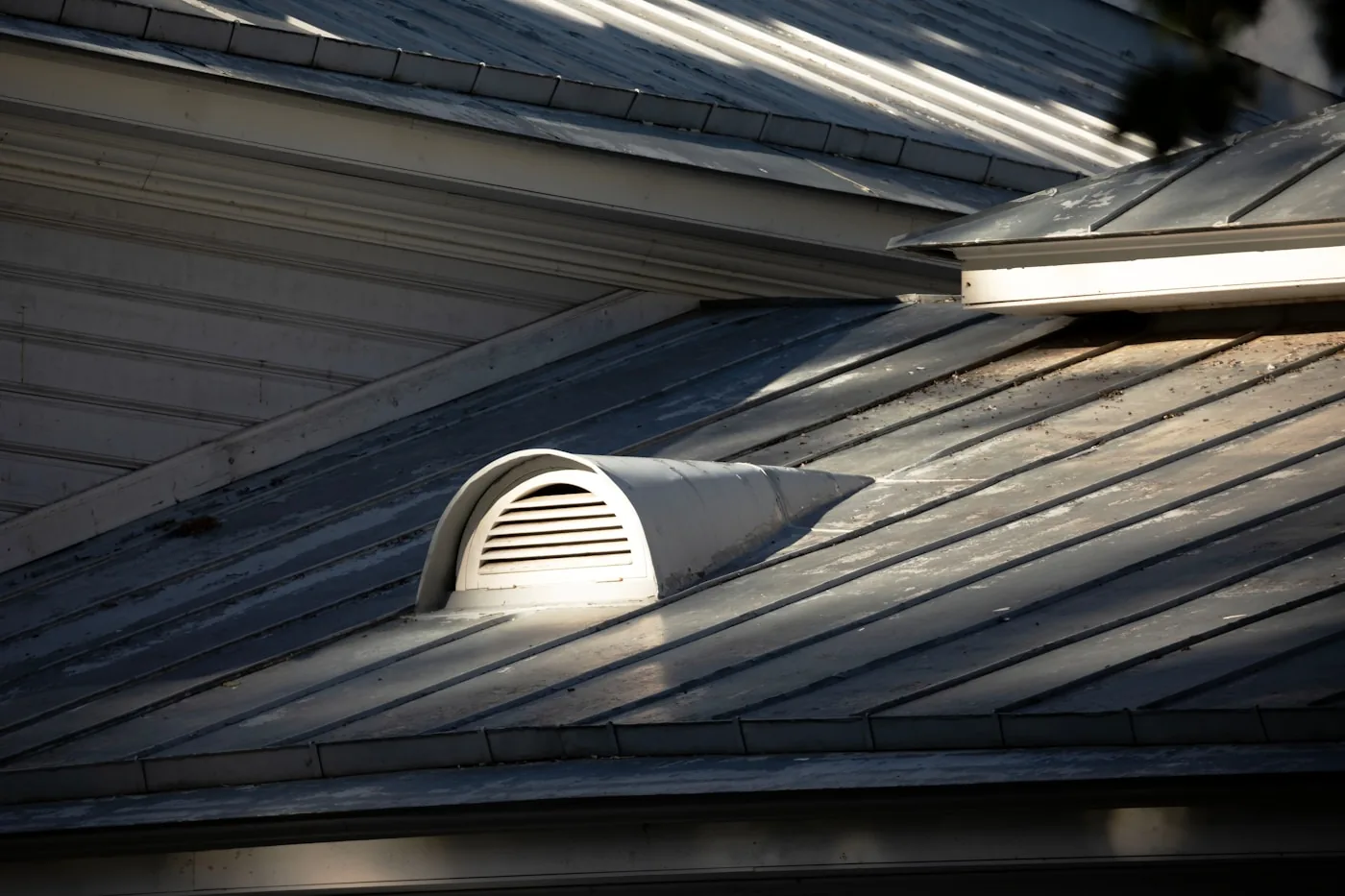 Sealing an exterior foundation gap with copper mesh and sealant to block rodents